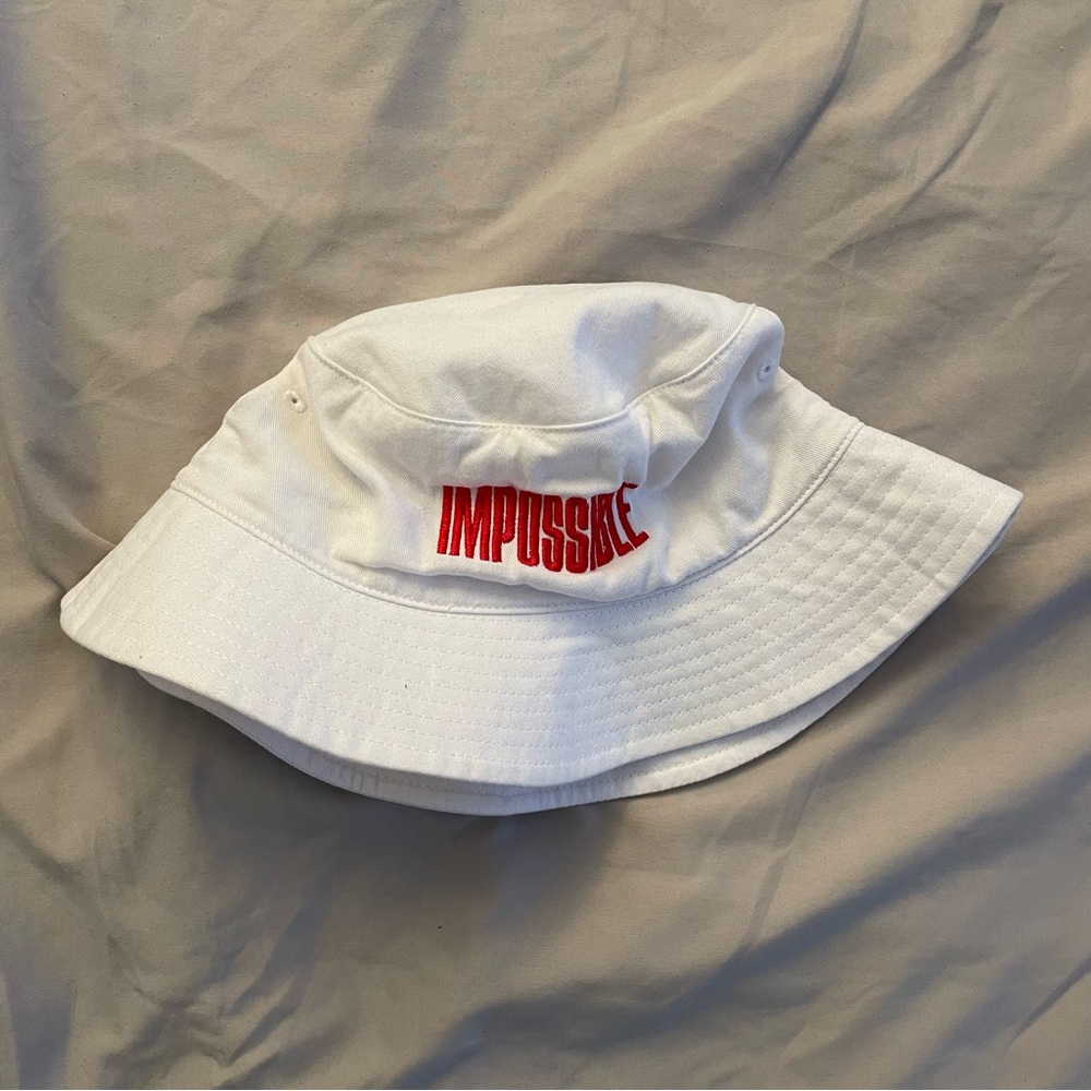 Impossible Foods white bucket hat with red embroidered logo text